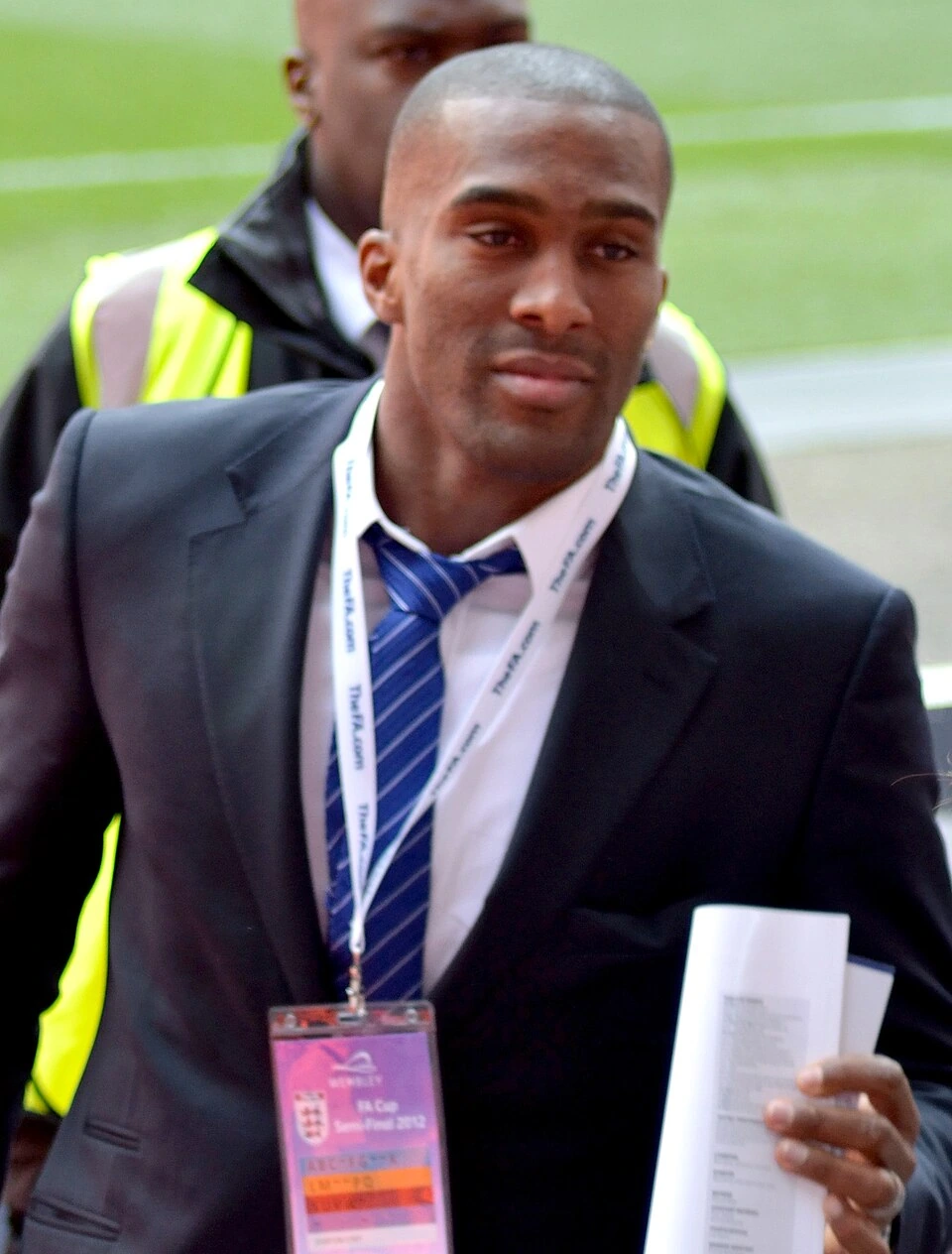 Sylvain Distin in a suit at a football event