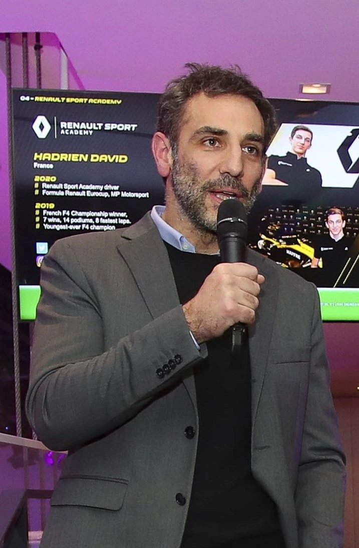 Cyril Abiteboul speaking into a microphone at an event
