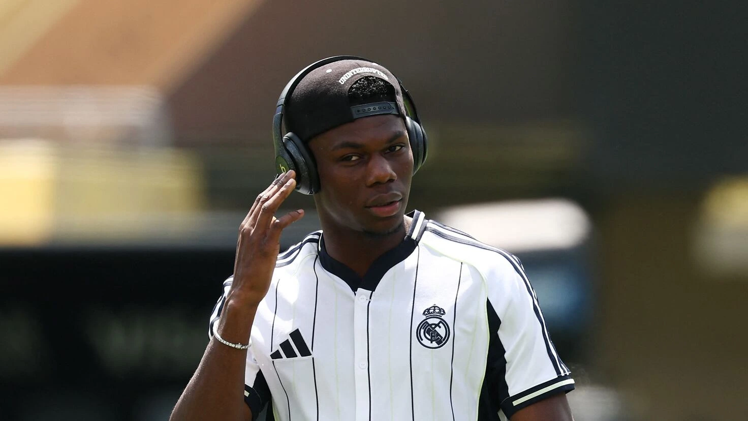 Aurélien Tchouaméni wearing a Real Madrid jersey and headphones