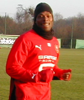 Sylvain Wiltord training outdoors in a red football kit
