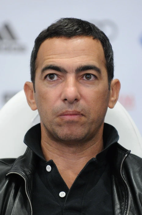 Portrait of Jean Djorkaeff outdoors in a suit